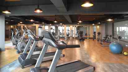 Gymnasium Interior With Treadmill in Malles ClubHouse